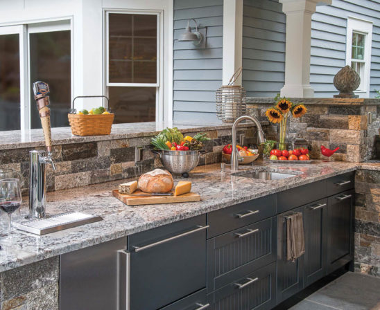 brown jordan outdoor kitchen with sink, keg line, and marble countertops