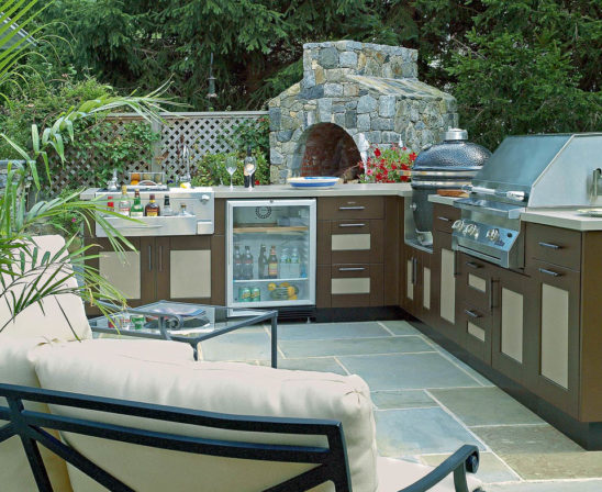 outdoor kitchen with big green egg built in, stone pizza oven