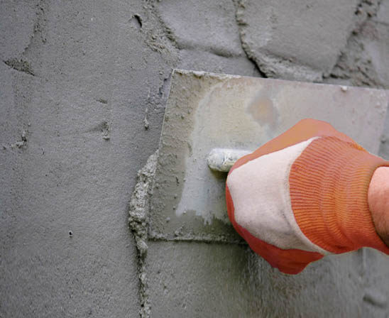 stucco being applied by trowel