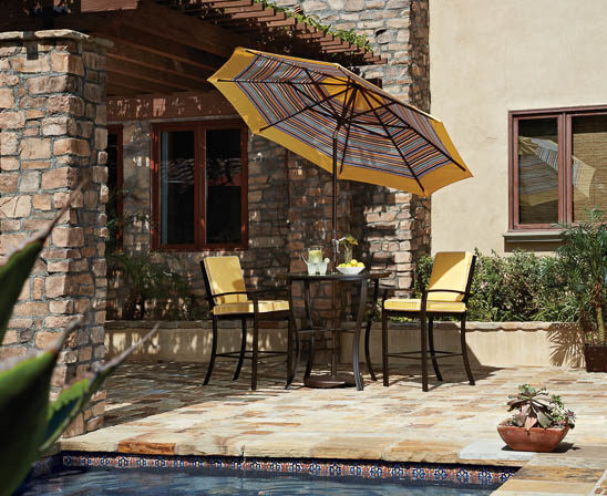 treasure garden umbrella with striped fabric through umbrella hole in bar height table