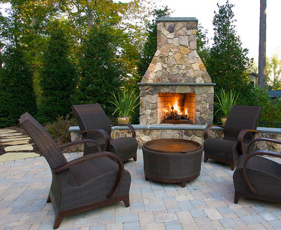 isokern outdoor fireplace with outdoor living furniture on brick patio