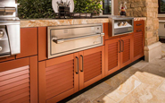 danver outdoor kitchen with louvered doors in brown wood grain finish