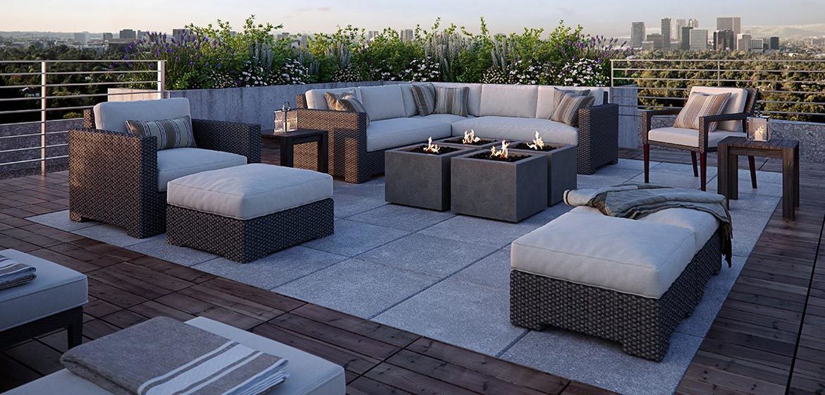 eldorado outdoor bloc fire bowl group on rooftop deck with wicker furniture and city skyline