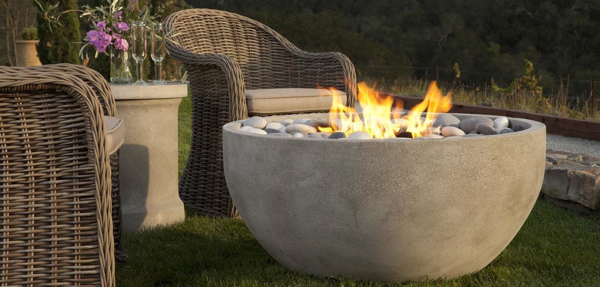 eldorado outdoor infinite fire bowl near bocce court with wicker seating closeup