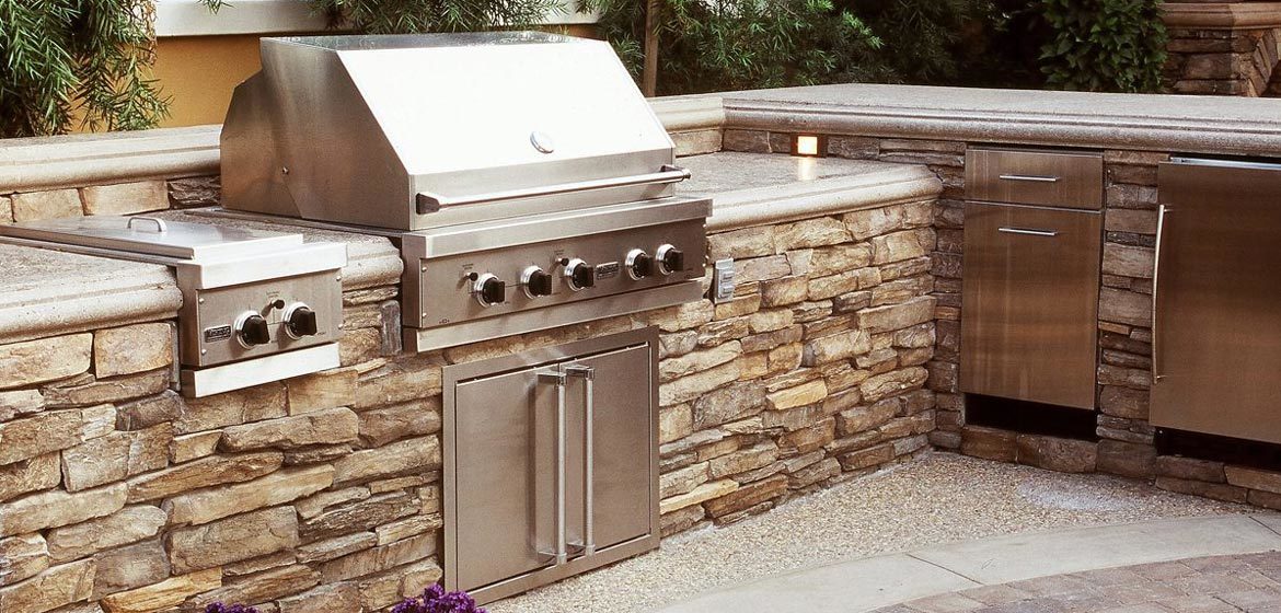 eldorado outdoor kitchen with stackstone riverstone veneer and built in grill