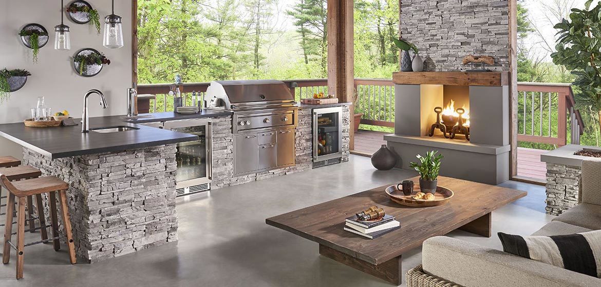 eldorado outdoor kitchen with grey stackstone and built in grill and stainless steel beverage refrigerator