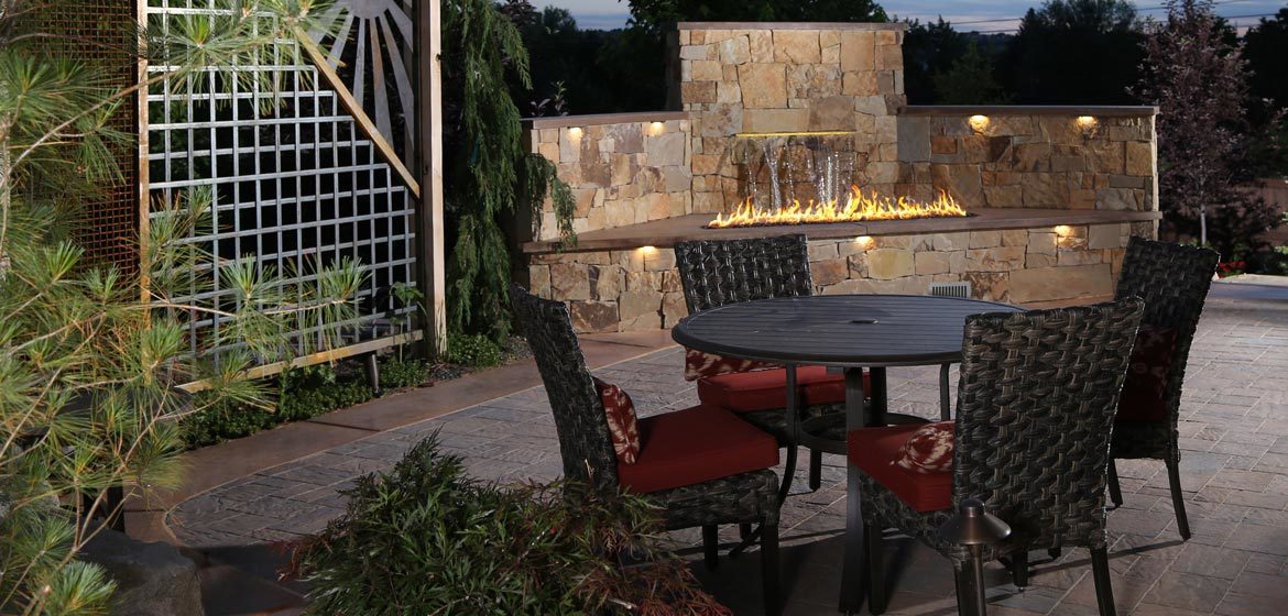 firegear outdoors l-series linear burner on concrete paver patio with cantilever umbrella and wicker outdoor dining furniture