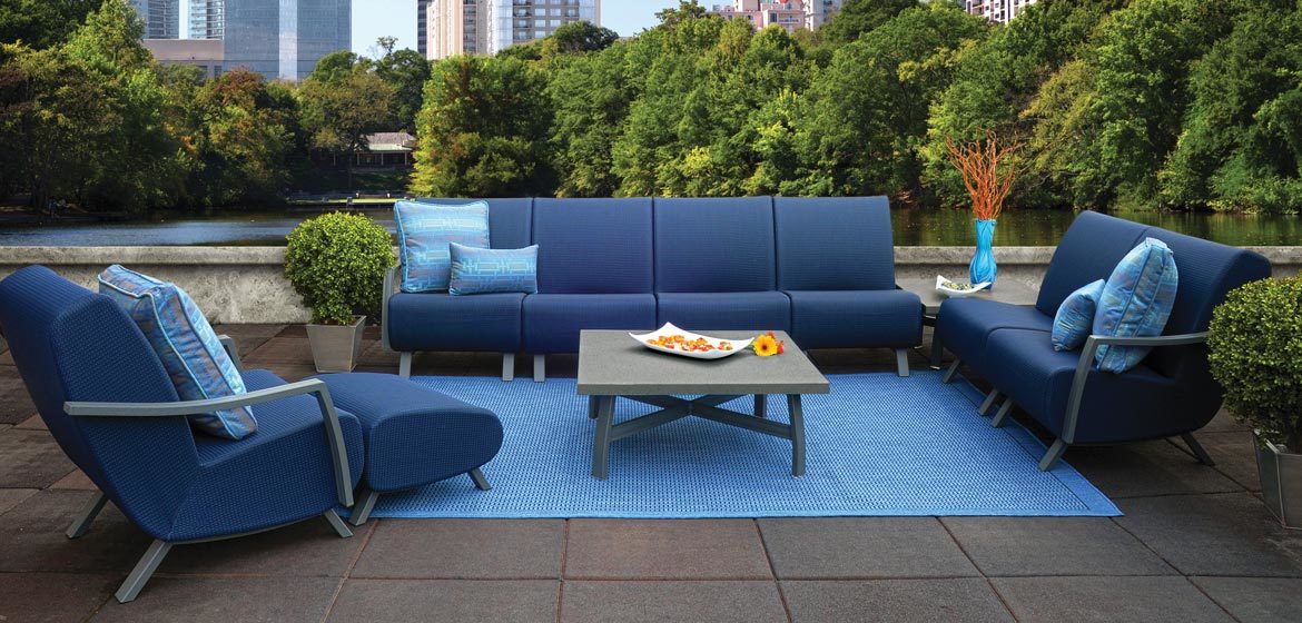 Homecrest Airo2 outdoor sectional sofa on rooftop patio with city skyline