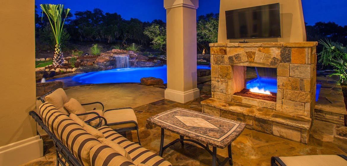 isokern see through outdoor fireplace interior view on flagstone patio with wrought iron sofa