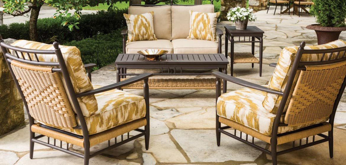 Lloyd Flanders Low Country outdoor cushion seating with love seat and lounge chairs on irregular flagstone patio