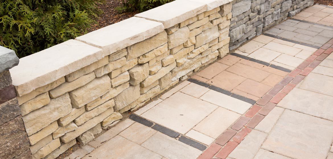 outdoor showroom with built in samples of Unilock concrete pavers and retaining wall block