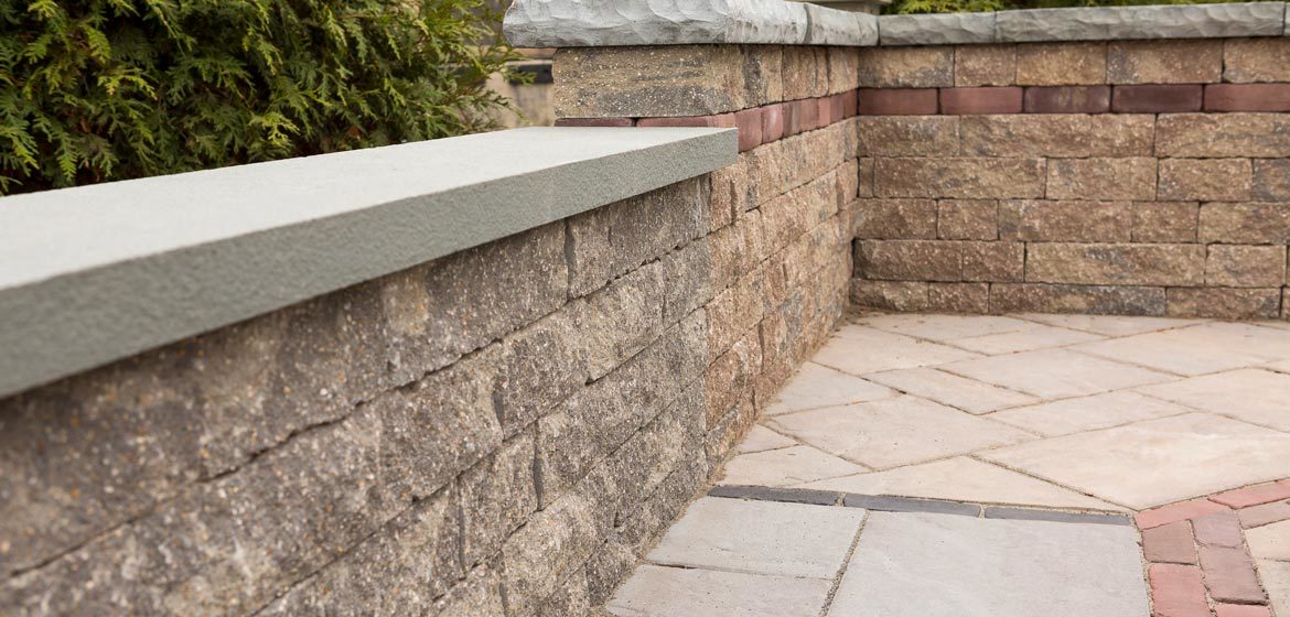 outdoor showroom with built in samples of unilock concrete pavers and retaining wall block