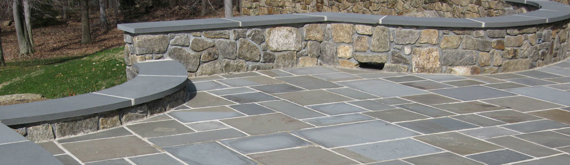 thermalled pennsylvania bluestone mortared in with natural landscape stone seat wall and custom fabricated bluestone coping