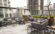 unilock delconca porcelain landscape tile on rooftop patio rooftop deck with contemporary outdoor sectional sofa and cantilever umbrella and outdoor lanterns