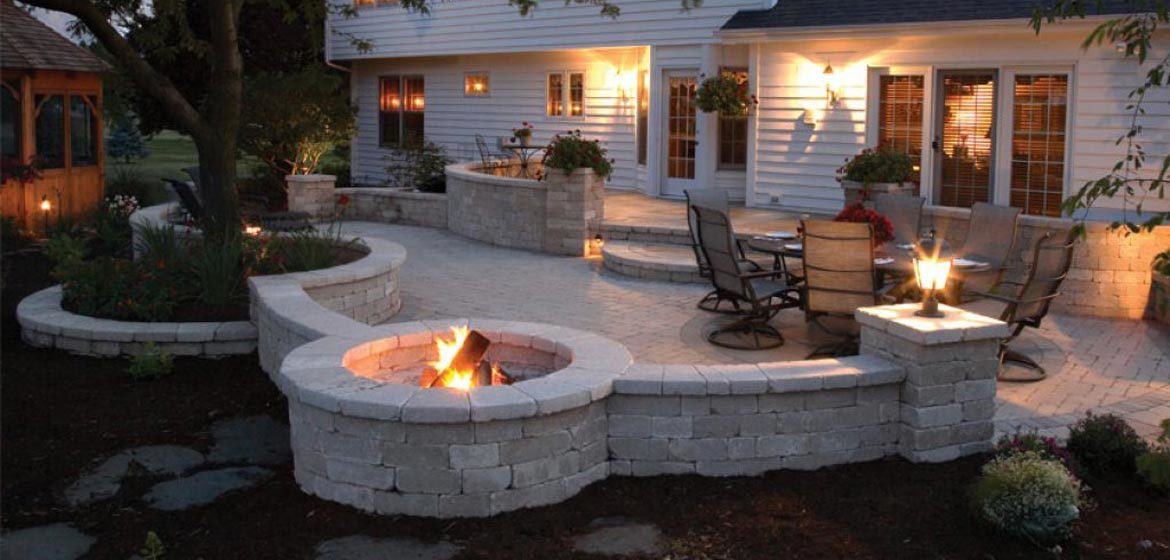 unilock brussels patio with built in round fire pit