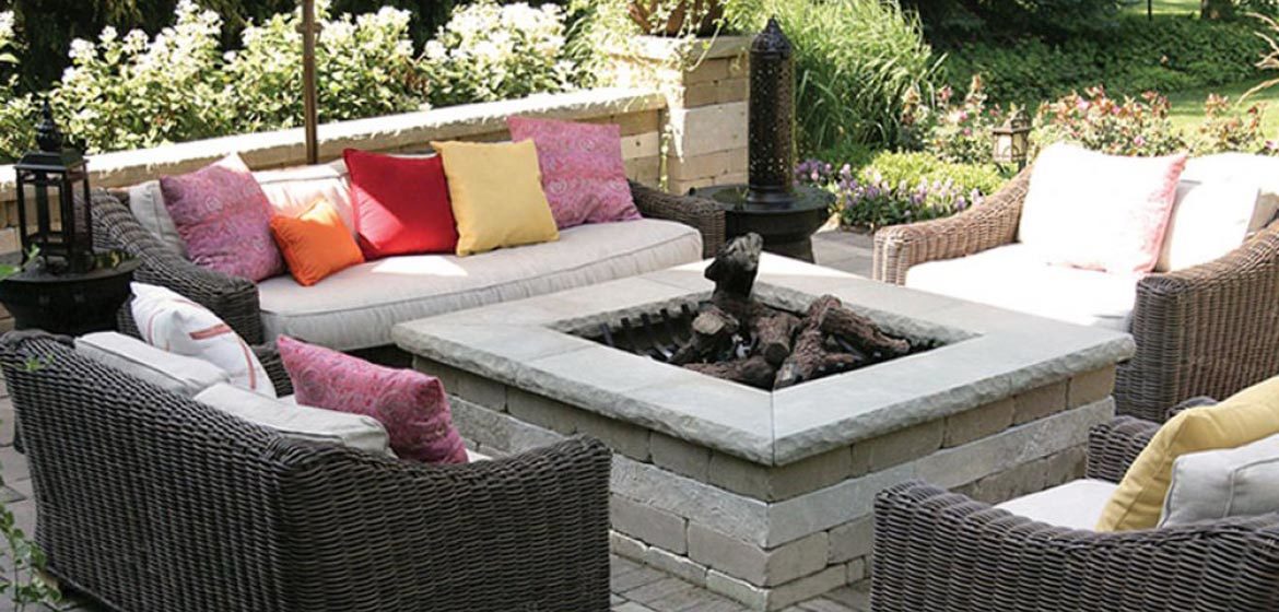 unilock brussels square fire pit with ledgestone coping and all weather wicker outdoor furniture