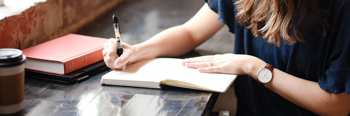 woman creating patio plan in notebook