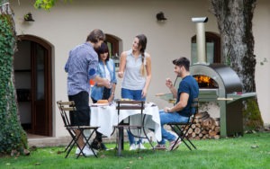 Friends gathered around ALFA 4 Pizze oven