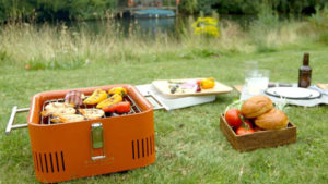 the everdure cube is a portable charcoal grill that is perfect for tailgating, picnicking or camping