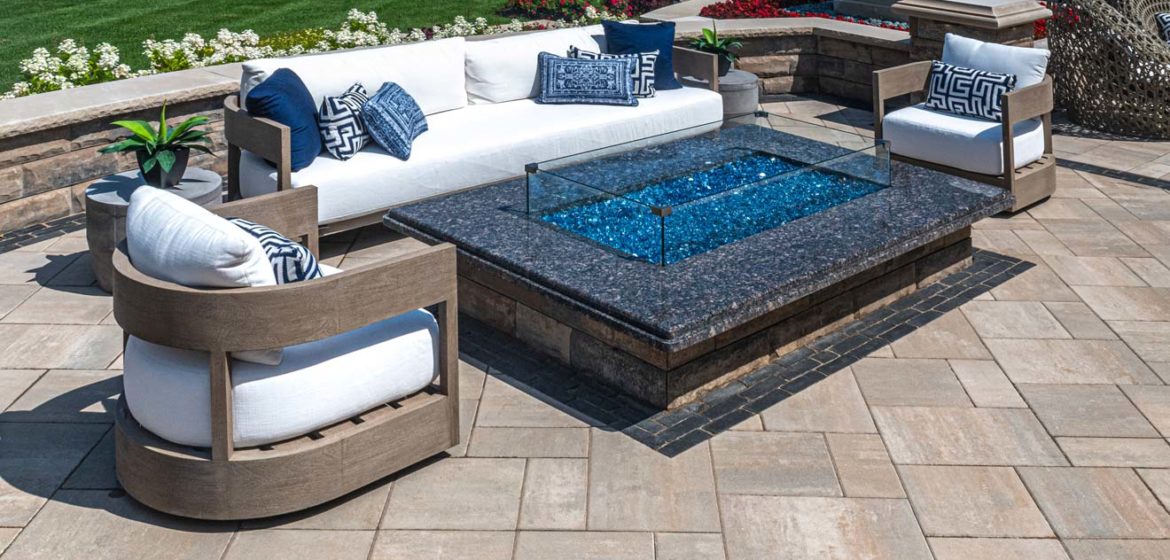 unilock beacon hill smooth patio pavers and u-cara pitched face seating wall near a beautiful golf course