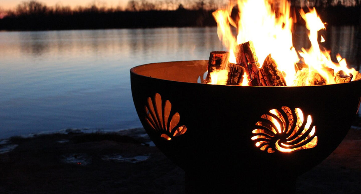 Firepit by a lake at night.