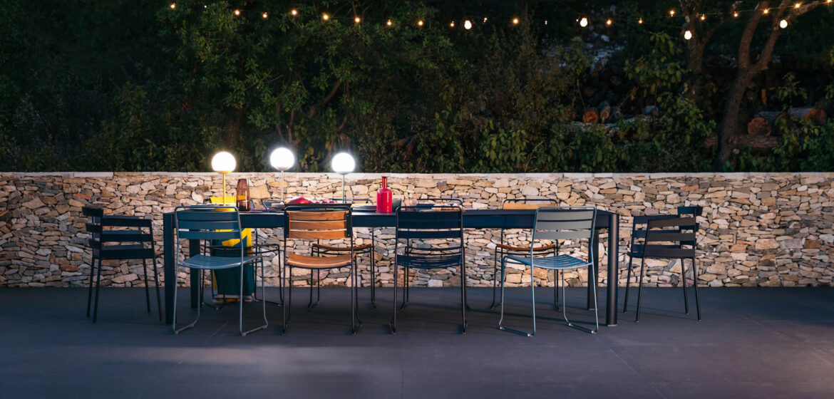 Fermob moon lamps Illuminating an outdoor dining area.