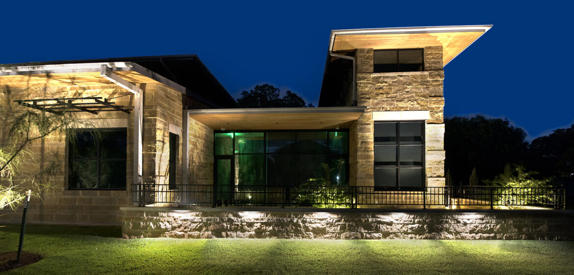 A modern building illuminated at night.